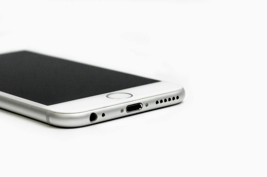 Minimalist image of a sleek smartphone with focus on the bottom edge and ports.