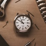 silver and white analog watch at 10 10