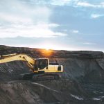 yellow and white excavator on rocky mountain during daytime
