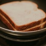 a close up of a sandwich in a pan on a stove